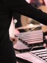 Clear mallets in girl's hand with glockenspiel and marimba