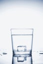 Clear mineral water splashes in a glass with ice Royalty Free Stock Photo