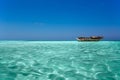 Clear ocean maldives water under blue sky with abandoned boat Royalty Free Stock Photo