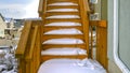 Clear Panorama Outdoor wooden staircase of a home covered with snow during winter season