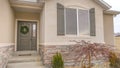 Clear Panorama Pathway and stairs leading to the gray front door with wreath and sidelight