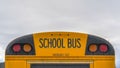 Clear Panorama Rear of a yellow school bus with signal lights and emergency exit window Royalty Free Stock Photo