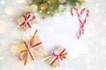 Clear paper laying with candy cane, Christmas tree branches and gifts Royalty Free Stock Photo