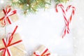 Clear paper laying with candy cane, Christmas tree branches and gifts Royalty Free Stock Photo