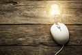 clear pixel image of computer mouse connected to a light bulb Royalty Free Stock Photo