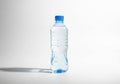 Clear plastic bottle of refreshing water with blue cap on white background Royalty Free Stock Photo