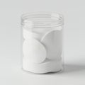 A clear plastic container holds a stack of round, white cotton pads. The container is Royalty Free Stock Photo
