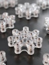 Clear Plastic Game Pieces Arranged on a Dark Surface Showcasing Intricate Designs and Textures While Highlighting Their Royalty Free Stock Photo