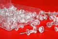 Clear Push Pins on a Red Background Royalty Free Stock Photo