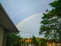 Clear rainbow over small town and buildings of Tineo, Asturias,