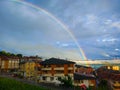 Clear rainbow over small town and buildings of Tineo, Asturias, Royalty Free Stock Photo