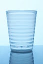 Clear ribbed glass cup.