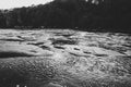 Clear river with rocks leads towards mountains. lit by sunset. Mountain fast flowing river stream of water in the rocks with blue Royalty Free Stock Photo