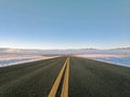 Clear Road in Snow Looking At Wind River Canyon Snow Squall In Distance in Wyoming in Winter