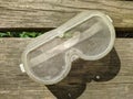 clear safety glasses for construction on a wooden background