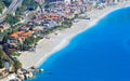 Clear sea, hotels and pebbly beach near Mazzeo Messina on east coast of island of Sicily, Italy