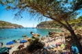 Clear sea and pebble beach with vacationers in Anthony Quinn bay in Rhodes island in Greece