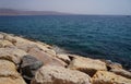 Clear sea water surface, stones and glare