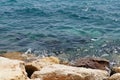 Clear sea water surface, stones and glare