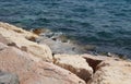 Clear sea water surface, stones and glare