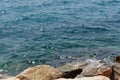 Clear sea water surface, stones and glare