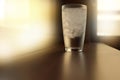 Clear single glass with cold water with ice on counter in bar or Royalty Free Stock Photo