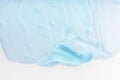 Clear skincare product smudge closeup. Cream gel blue transparent cosmetic sample with bubbles isolated on white