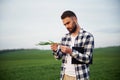 Clear sky. Handsome young man is on agricultural field