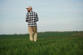 Clear sky. Handsome young man is on agricultural field