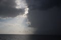 Clear sky and storm clouds on the sea. half the sky is clear, half are storm clouds. hurricane coming. storm coming on the ocean, Royalty Free Stock Photo