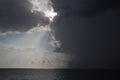 Clear sky and storm clouds on the sea. half the sky is clear, half are storm clouds. hurricane coming. storm coming on the ocean, Royalty Free Stock Photo