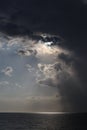 Clear sky and storm clouds on the sea. half the sky is clear, half are storm clouds. hurricane coming. storm coming on the ocean, Royalty Free Stock Photo