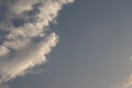 A clear sky with white cottony clouds on a corner