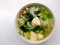 Clear Soup with Bean Curd , mix vegetable, Tofu and seaweed in white bowl on white background. Vegetarian Food, Healthy food, Thai Royalty Free Stock Photo