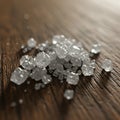 Clear, sparkling sugar crystals are scattered on a wooden surface, showcasing a Royalty Free Stock Photo