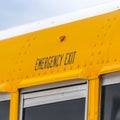 Clear Square Close up of the exterior of a yellow school bus with an Emergency Exit sign Royalty Free Stock Photo