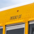 Clear Square Close up of the exterior of a yellow school bus with an Emergency Exit sign