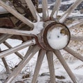 Clear Square Close up of the wooden wheel of an old wagon against a snowy terrain in winter Royalty Free Stock Photo