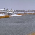 Clear Square Oquirrh lake with view of snowy lakefront homes