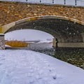 Clear Square Snowy trail along lake and passing under a bridge