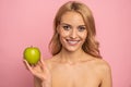 Clear strong white straight teeth stomatology concept. Portrait of attractive charming nude natural model having green apple in Royalty Free Stock Photo