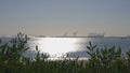 Clear sunny day in California. View of the cargo port at Long Beach USA. Sun glare on the birch water of the ocean. Royalty Free Stock Photo