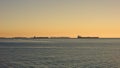 Clear sunny day in California. View of the cargo port at Long Beach USA. Sun glare on the birch water of the ocean. Royalty Free Stock Photo