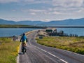 On a clear, sunny day a single cyclist heads for the causeway connecting the islands of North Uist and Berneray Royalty Free Stock Photo