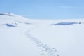 Clear sunny sky with skiing tracks in a winter landscape in snow covered mountains Royalty Free Stock Photo