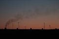 Clear sunrise or sunset sky with a smooth gradient of colors. Dark silhouettes of the roof of the building with antennas and pipes