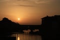 skyline of buildings and bridge on a clear sunset.