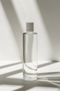 Clear transparent bottle standing upright with soft shadows and clean lines in minimalist setting Royalty Free Stock Photo