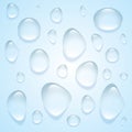 Clear transparent water drops isolated on the blue background.