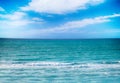 The clear turquoise sea of the Atlantic ocean on which are white waves. Above it is the blue sky. It`s in the Caribbean in Cuba